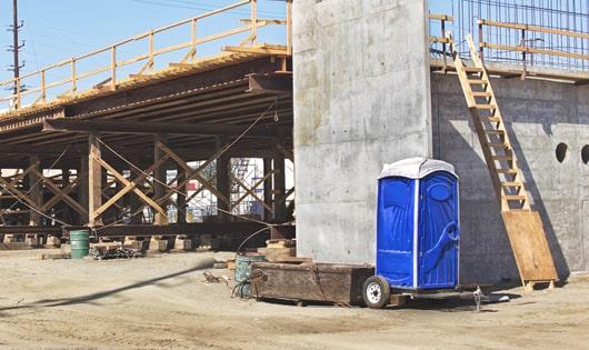 rows of portable toilets at a job site, providing essential amenities for workers